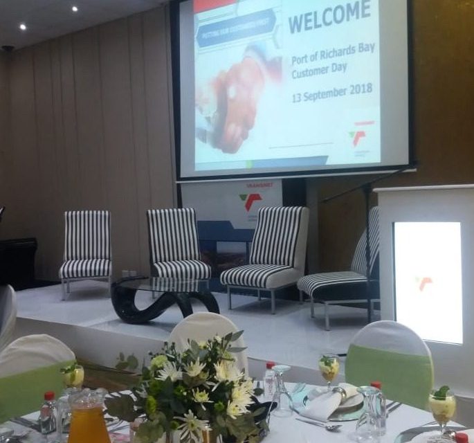 Corporate function with stage seating and projector screen