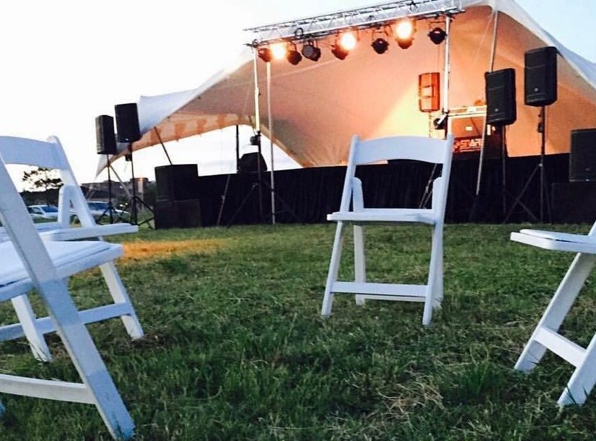 Outdoor stage with lighting rig and PA