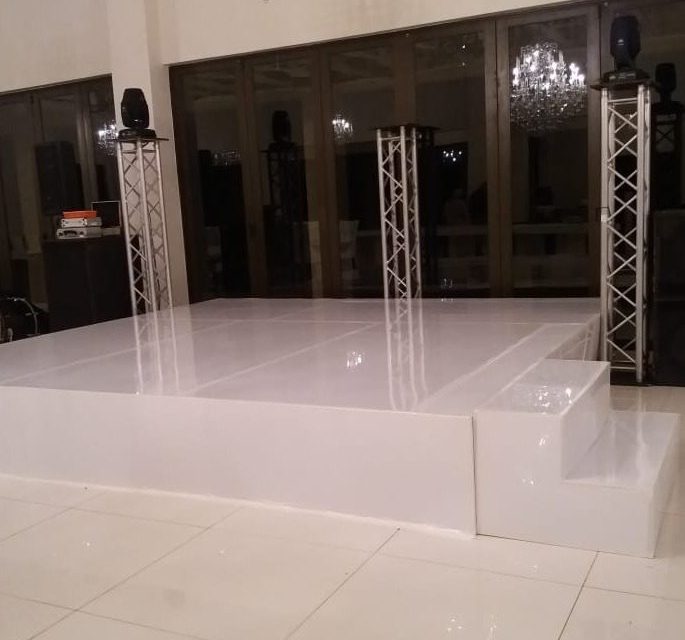 White stage with truss and speakers